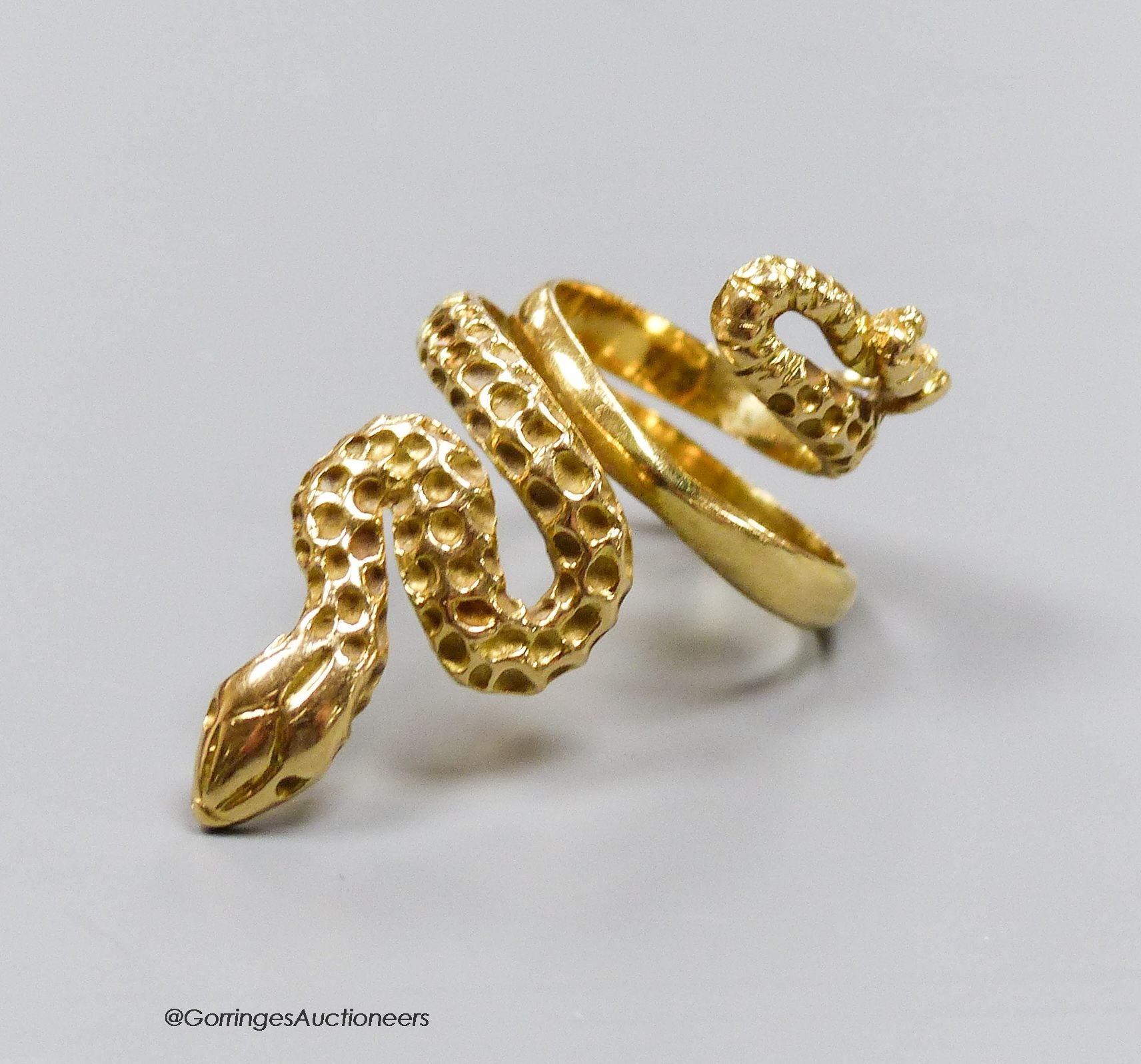 An 18ct gold (750) serpent ring, size F, 8.1g.